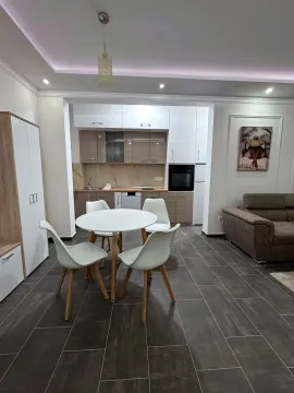 Living room with a dining area and an open-plan kitchen. - image 3