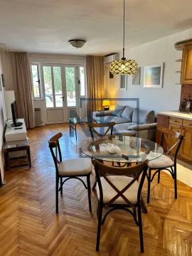 Living room with a dining area and parquet flooring. - image 3