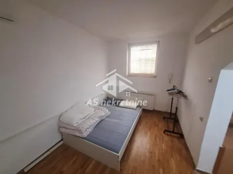 Small bedroom with a bed and a window. - image 29