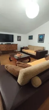 Living room furnished with a sofa set, coffee table, and TV console. - image 9