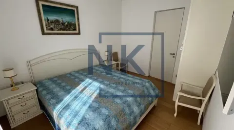 Furnished bedroom with a double bed, nightstands, and a painting on the wall. - image 10