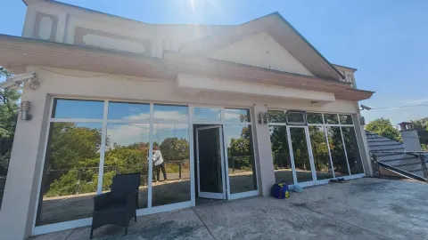 Exterior of the house with large glass surfaces and a terrace. - image 6