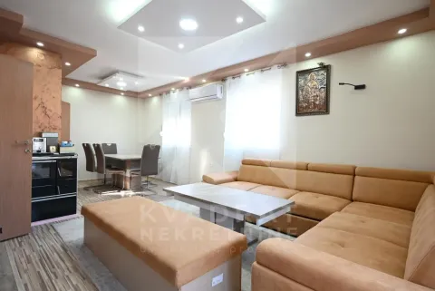 Living room with sofa, coffee table and dining area in the background. - image 4