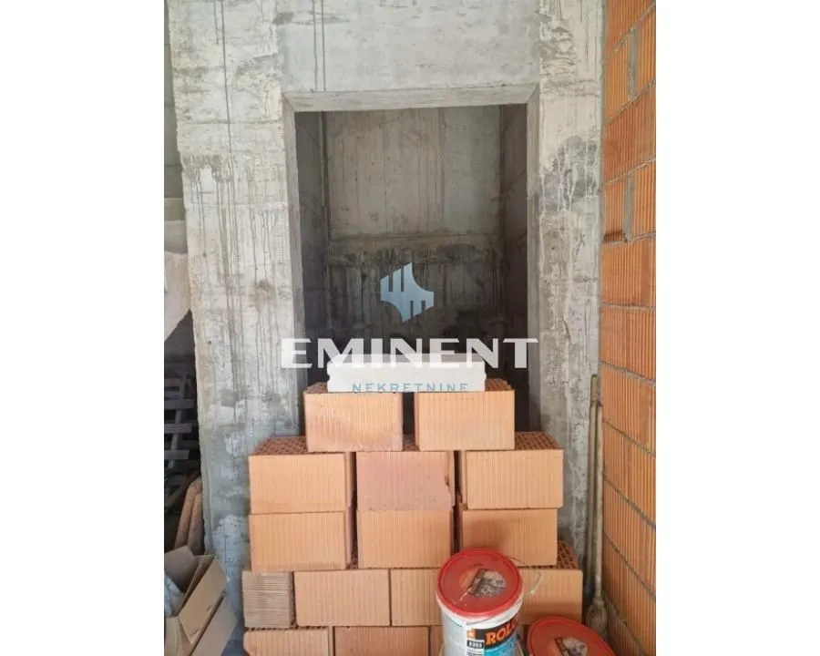 View of a property under construction with building materials.