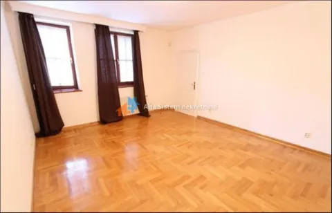 Empty room with parquet flooring and windows with dark curtains. - image 17