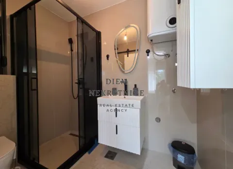 Modern bathroom with walk-in shower, washbasin, and mirror. - image 6
