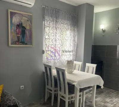 Dining table with white chairs by the window in the living room. - image 5