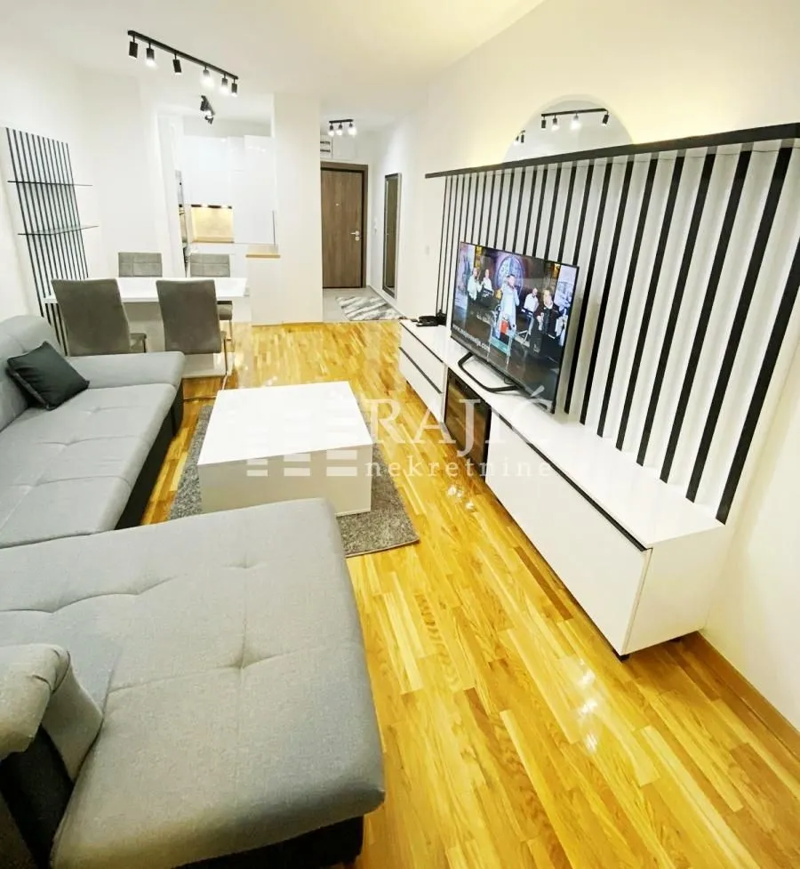 Modern and bright living room with sofa and dining area.