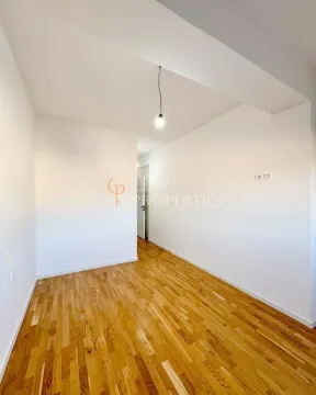 Empty room with parquet flooring and white walls. - image 11