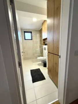 View from the hallway into a modern bathroom with a walk-in shower. - image 13