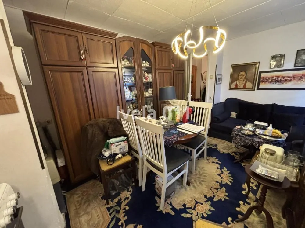 Living room with seating furniture and a dining area.