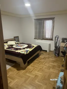 Bright bedroom with a double bed and parquet flooring. - image 20