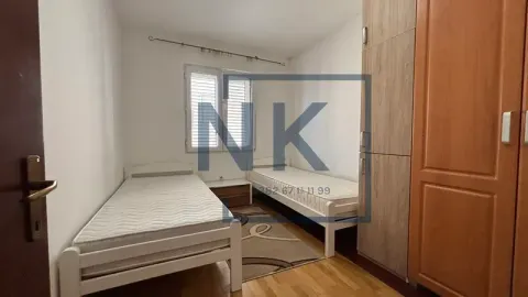 Small bedroom with two single beds and wardrobes. - image 7