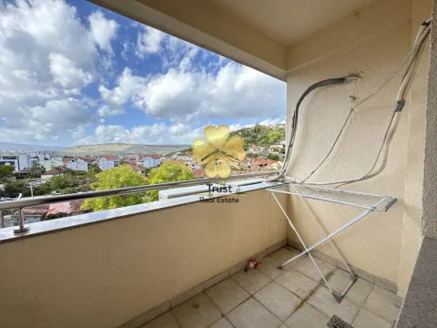 Small covered balcony with a view of the city and surrounding hills. - image 5
