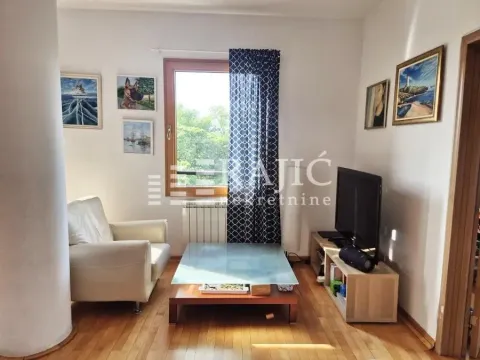 Living room with sofa, coffee table, and television. - image 2