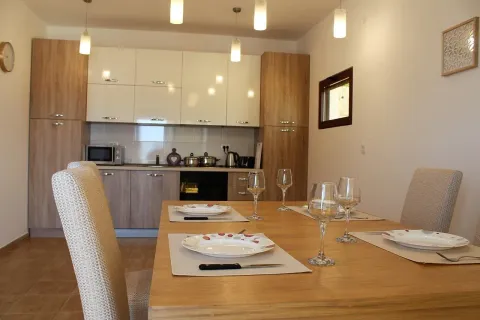 Modern kitchen with a dining table and set tableware. - image 4