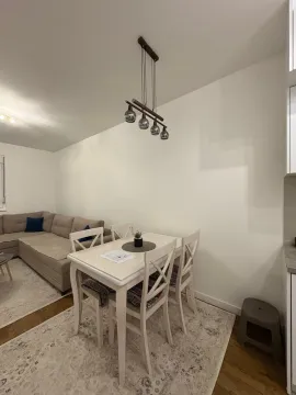 Living room with a dining table and a corner sofa. - image 4