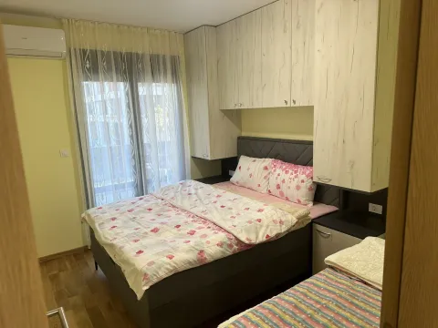 Bright bedroom with a double bed and built-in wardrobes. - image 6
