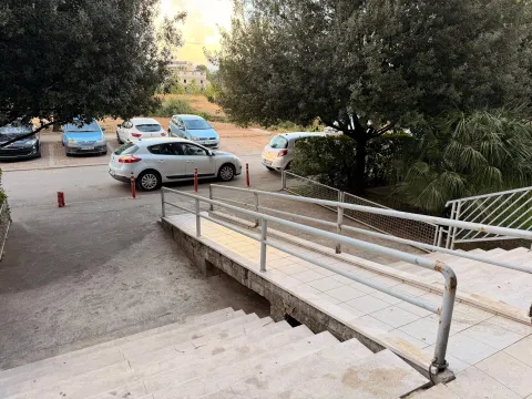Building entrance with stairs, ramp, and parking in the yard. - image 12
