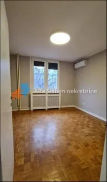 Empty room with parquet flooring and an air conditioner. - image 6