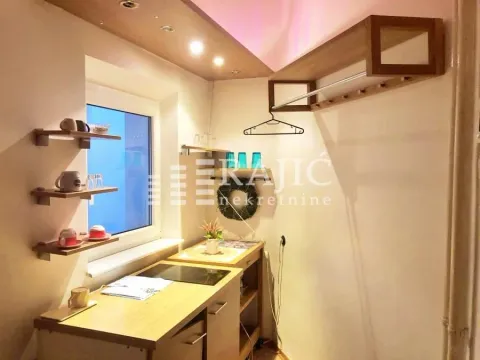 Small kitchen with built-in units and shelves by the window. - image 4