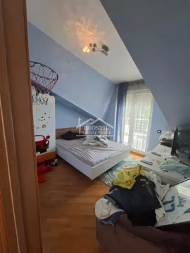 Children's attic bedroom with a bed and sloped ceiling. - image 11
