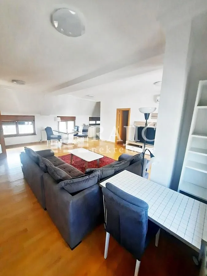 Spacious living room with a sofa set and dining area.
