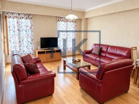 Living room with red leather sofa set and wooden furniture. - image 2