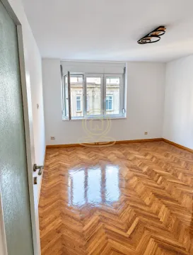 Empty room with parquet flooring and white walls. - image 5