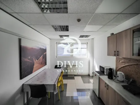 Kitchen with a dining table and fitted cabinets. - image 14