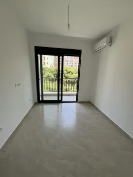 Empty room with access to a balcony and an air conditioning unit. - image 3