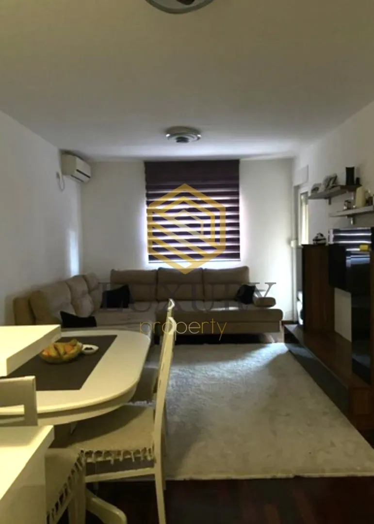 Living room with a sofa and dining table.
