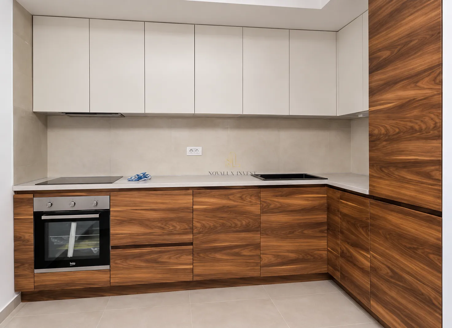 Modern kitchen with wooden cabinetry, built-in oven, and hob.