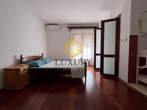 Spacious bedroom with a double bed, wooden flooring, and access to the terrace. - image 3