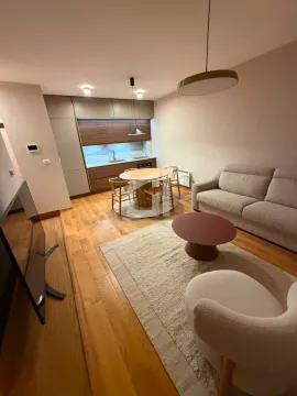 Open-plan living room with dining area and kitchen. - image 2