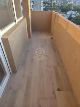 Prazan balkon sa podom u imitaciji drveta i bež zidovima. - image 16