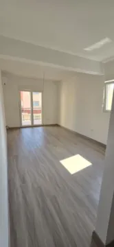 Prazna neopremljena prostorija sa laminatom na podu i izlazom na terasu. - image 8