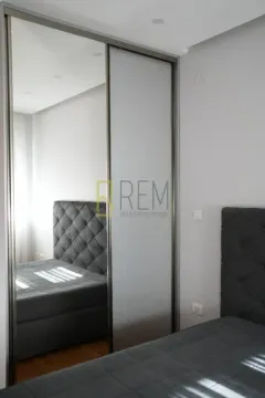 Modern bedroom with a double bed and a mirrored built-in wardrobe. - image 3