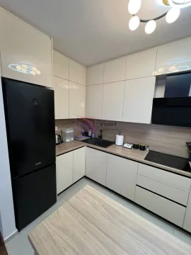 Modern kitchen with built-in cabinetry and a black refrigerator. - image 7