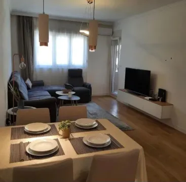 Living room with dining area and sofa. - image 2