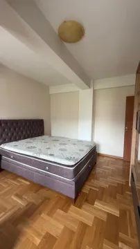 Furnished bedroom with a double bed and parquet flooring. - image 3