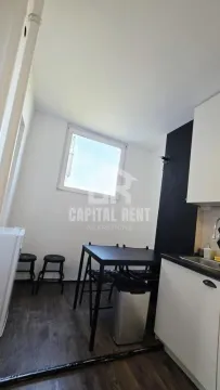 Small kitchen with a dining table and chairs. - image 3