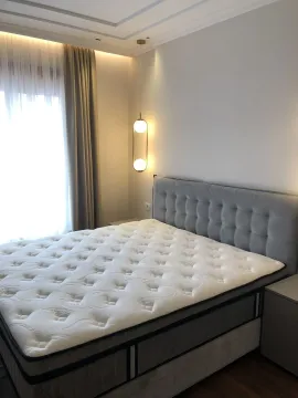 Bright bedroom with a modern bed. - image 18