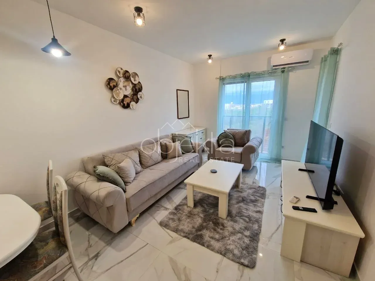 Living room with sofa, coffee table and television.