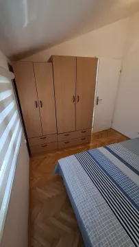 Furnished bedroom with a wardrobe and bed. - image 6
