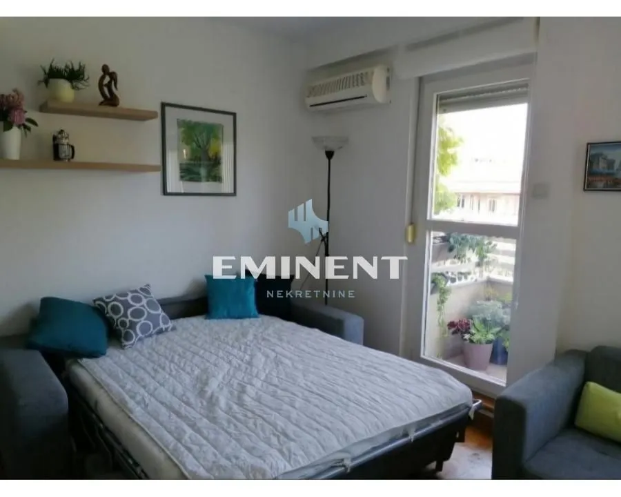 Small bedroom with a sofa bed and access to the terrace.