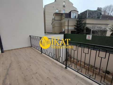 Spacious terrace with wooden flooring and a black railing. - image 7