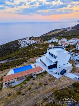 Aerial view of a modern villa with a swimming pool and sea view. - image 33