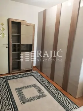 Furnished bedroom with a large wardrobe and a carpet. - image 7