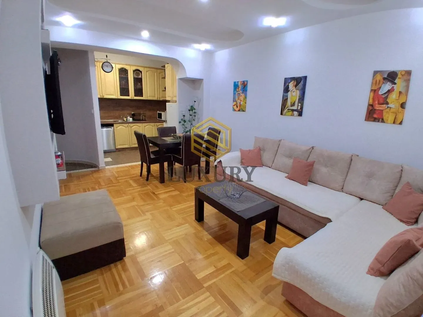 Living room with a sofa set and dining area in an open plan layout.